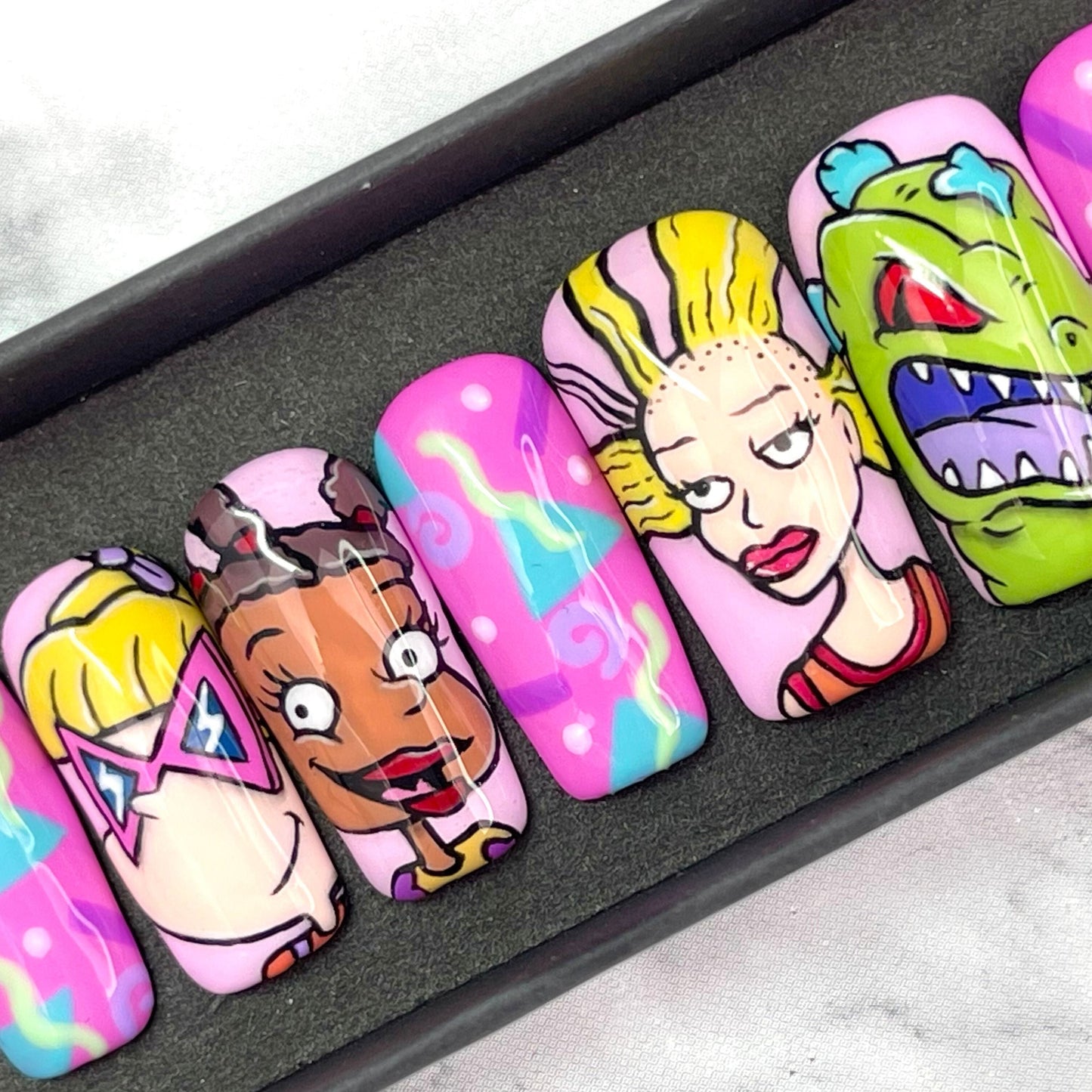 hand painted Rugrats press on nails with Angelica, Suzie, Cynthia and Reptar